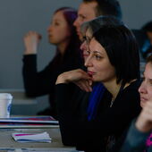 Some listeners in the audience listen attentively