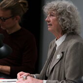 Ulrike Ottinger recites in front of a microphone, next to her sits Dirk Naguschewski
