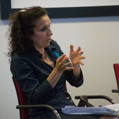 Nora Laafi gestures while sitting.