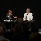 Wide shot of Christina Pareigis talking to Stephan Thome in front of an audience