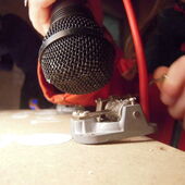 Close-up eines Mikrofons, das an eine kleine Spieluhr gehalten wird