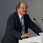 Dietrich Nelle stands behind the lectern and speaks