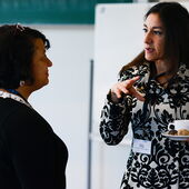 A visitor talks with Beran Turam from Boston