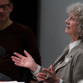Ulrike Ottinger recites in front of a microphone, next to her sits Dirk Naguschewski