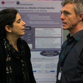 Sonja Hegasy and Hagen Findels talking in front of a poster