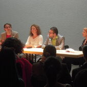 The four authors sit on a podium. Falko Schmieder speaks to the audience.