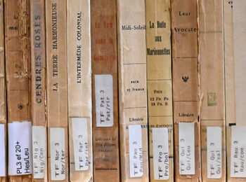 Back cover of old French books with library signatures.