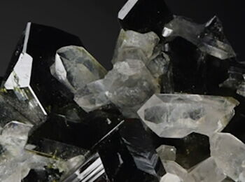 A book cover featuring the title and author in the top third, with a collection of various white and black stones and crystals below.