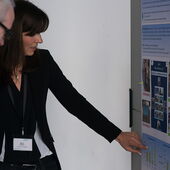 Maria Pohle points to a smartboard and explains a diagram