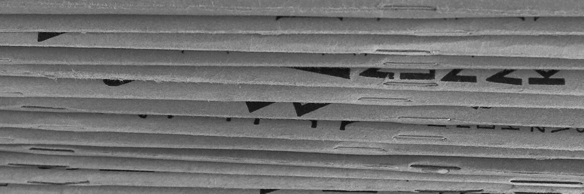 Detail of black and white photo of stacked magazines.