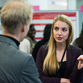 Christina Färber in conversation, pointing in front of her with her index finger