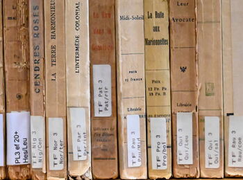 Back cover of old French books with library signatures.