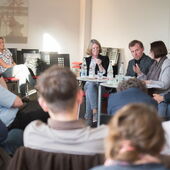 Teilnehmer*innen der Podiumsdiskussion sitzen in einem Stuhlkreis, Irina Scherbakowa spricht.