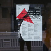 The poster for the ZfL annual conference “Counterworlds” hangs in a large window.