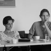 Black and white photograph of two female conferees.