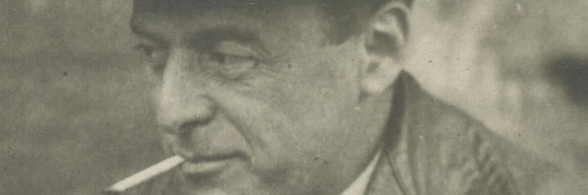 Close-up of Hermann Borchardt's face in black and white. He is wearing a leather jacket, has a cigarette in his mouth and is looking to the left.