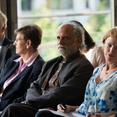Homi Bhabha sits in the audience in the front row and listens, surrounded by other audience members