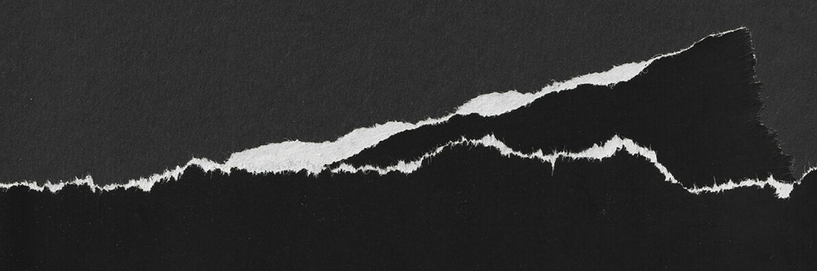 Black torn paper with white torn edges on a dark gray background, resulting in the outline of a mountain.